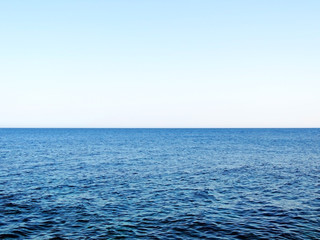 Open water with copy space. Sea scene and clear, blue sky.