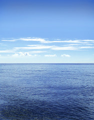 Fototapeta premium Open water with copy space. Sea scene and fluffy clouds.