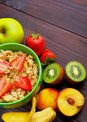 oatmeals in green plate decorated with slice of strawberry. Kiwi
