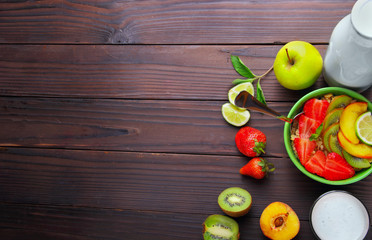 Oatmeals in green plate decorated with slice of strawberry, kiwi