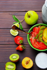 Oatmeals in green plate decorated with slice of strawberry, kiwi