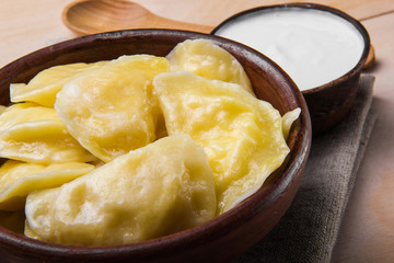 Naklejka na ściany i meble Vareniks (dumplings) with sour cream - national ukrainian cuisin