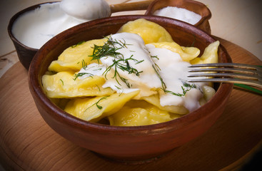 Vareniks  with sour cream and dill - national ukrainian cuisine.