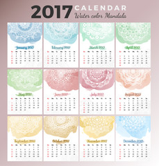 Printable monthly calendar 2017 design with colors of seasons and mehndi tattoo on watercolor paint. Vector illustration