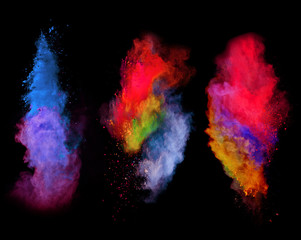 Explosions of colored powder on black background