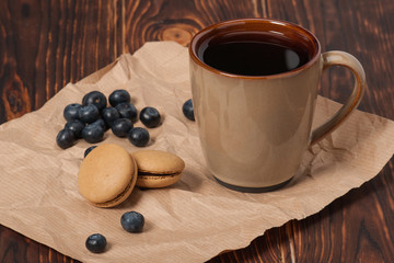 Macaroon Biscuits, Blueberries On Paper. Wooden Table