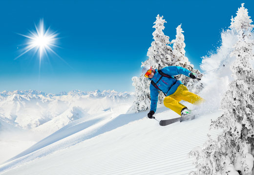 Skier on piste running downhill