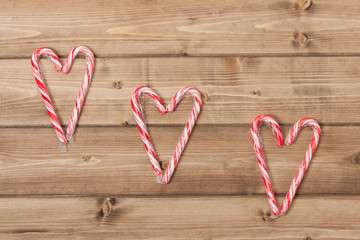 Christmas Background. Candy Canes, Heart Shape. Wooden Table Wit