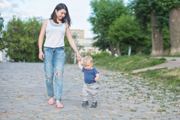 Fototapeta premium mother walking on the old road with her baby