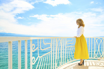 Love summer. Full length shot of an elegant woman standing at the terrace and enjoying the panoramic sea view.