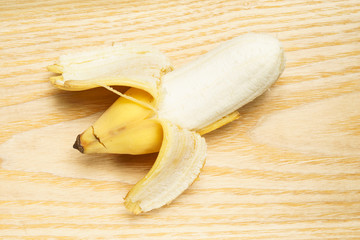 A stripped thick banana taste like apples on wood background © masakato11