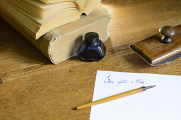 Phrase “Once upon a time” beautifully handwritten on a sheet of paper, surrounded with an old...
