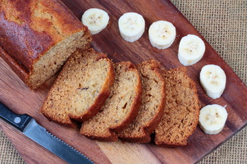 Homemade banana cake with sliced banana on butcher served.