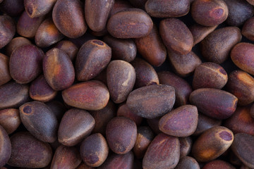 Pine nuts in shells. Background.