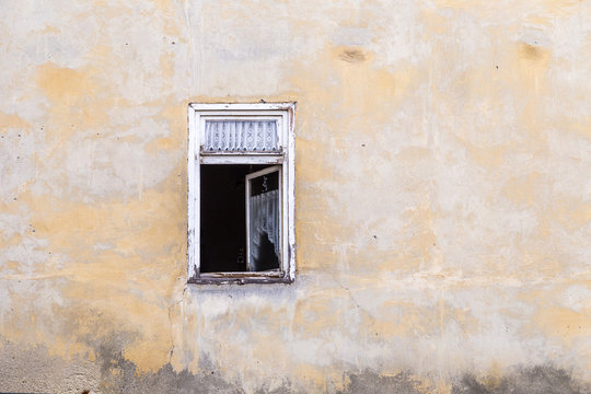 old open window at an abandoned house