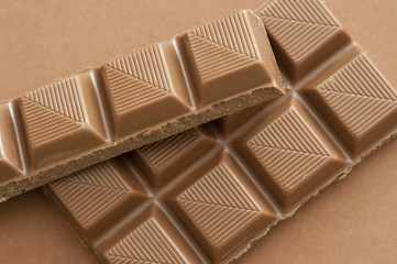 Broken bars of milk chocolate sections