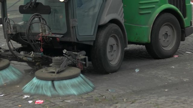 Car is cleaning the road. Garbage on the street. Reduce levels of pollution. Get rid of trash.