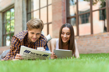Happy friends resting on lawn