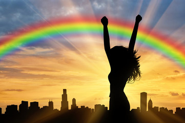 Happy woman on a rainbow background
