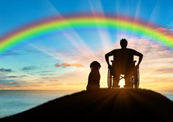 Disabled person in a wheelchair next to his dog