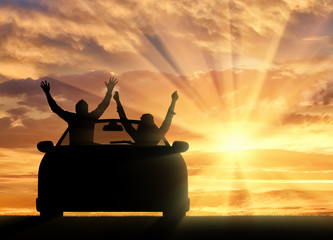 Happy people in the car meet the sunset