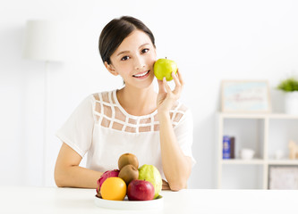 young beautiful woman eating healthy fruit