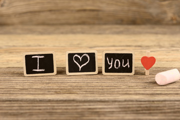 Words and letters I love you on a wooden background
