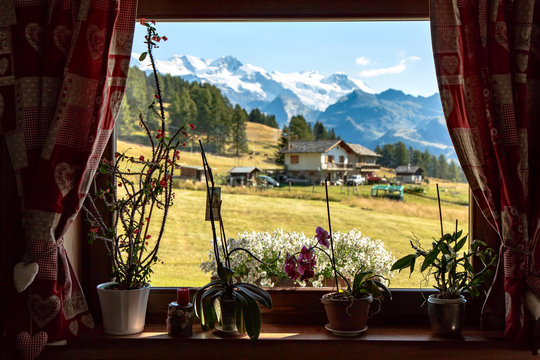 Fototapeta View through a chalet window of Val D'Ayas