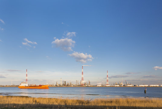 Refinery And River In Evening Sunlight