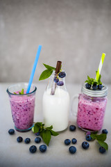 Delicious berry smoothies made with fresh ingredients on light background.
