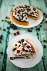 Delicious sponge cake with jelly and with fresh forest fruit with whipped cream and mascarpone.
