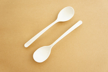 Twin spoons on brown background ,White spoon, The device is one of the cooking container. in eating