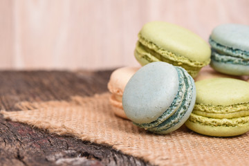 Macarons piled on burlap napkin in rustic setting