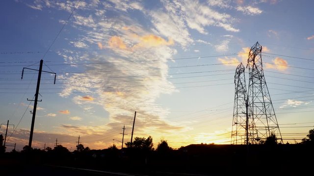 Silhouette electricity pylons in sunset background - ULTRA HD, 4k cable
