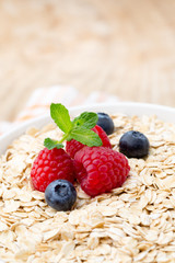 Oatmeal porridge with berries. Raspberries and blueberries.