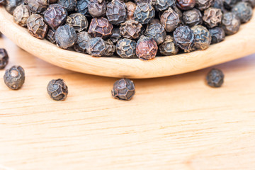 Macro of black peppercorns - black pepper grains.