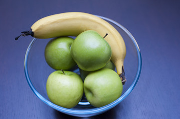Bowl with fresh apples and a banana