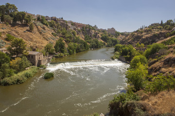 Fototapeta na wymiar Tagus river with ancient mill dam crossing Toledo City, Spain