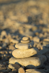 Fototapeta na wymiar Balance and harmony concept. Stones and rocks balance on the bea