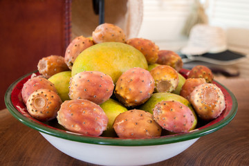 Naklejka na ściany i meble Mango and prickly pear cactus fruits in a plate.