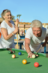 old couple playing billiards