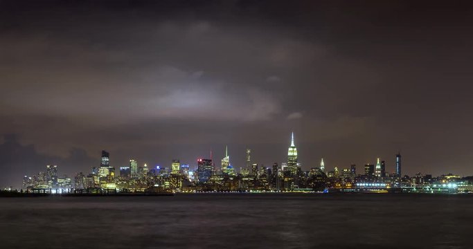 Cityscape time lapse of a summer evening storm and lightning in New York City. View of Manhattan Midtown West skyscrapers, West Village and Hudson River