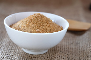 Ginger powder with sugar on sackcloth floor.