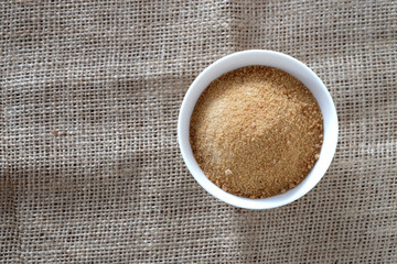 Ginger powder with sugar on sackcloth floor.