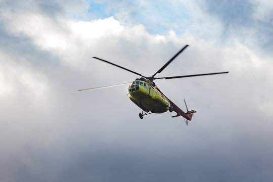 green helicopter in flight