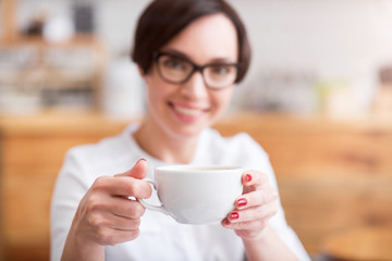 Attractive businesswoman holding cup