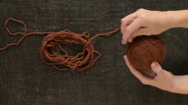 Clewing the brown yarn up
