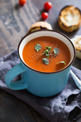 Tomato soup with herbs in a mug