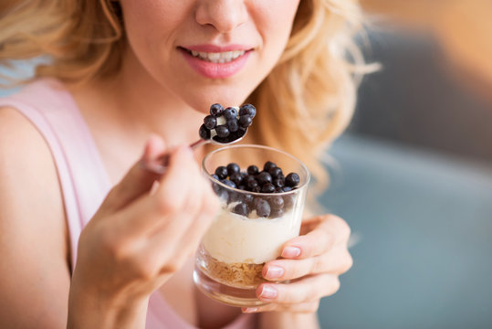 Sensitive Young Woman Eating Desert