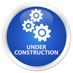 Under construction (gears icon) blue glossy round button